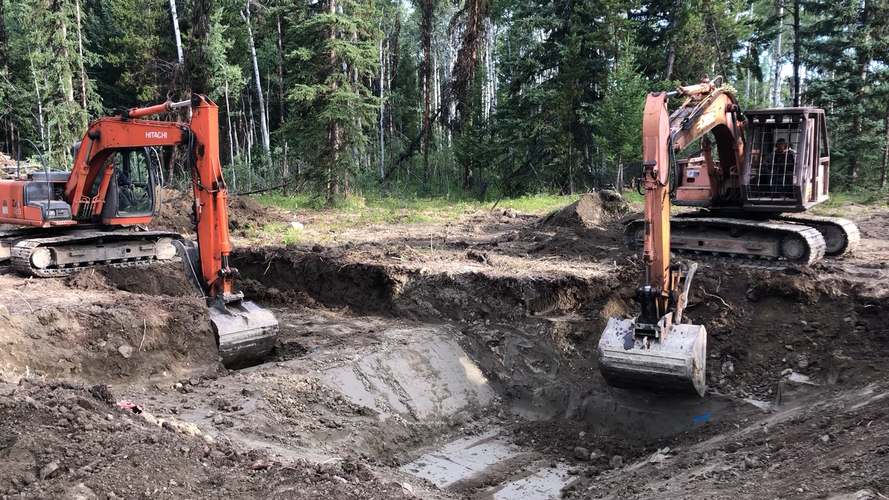 Scotty and Casey Lang working side-by-side to dig a local foundation (2021).